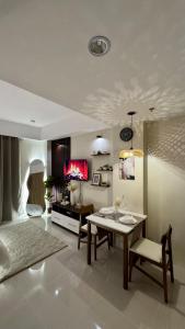 a living room with a table and a dining room at The A&R Stay-Mactan in Mactan +4 photos
