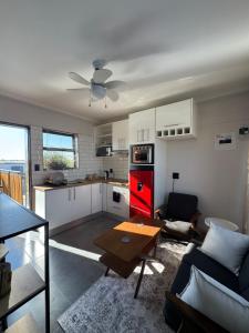 a kitchen and living room with a couch and a table at Ekuku retreat in Oshakati