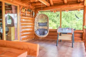 a room in a log cabin with a swing at Cabin Noah in Novi Marof