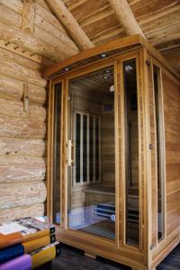 a wooden room with a glass door on a wall at Cabin Noah in Novi Marof +25 photos
