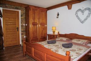 a bedroom with a large bed with a heart on the wall at Cabin Noah in Novi Marof