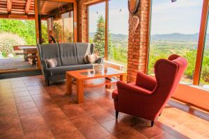 a living room with two chairs and a coffee table at Cabin Noah in Novi Marof
