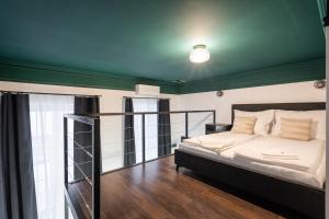 a bedroom with a bed and a green ceiling at E41 - Trendy Boutique Apartments - Prime Spot by BQA in Budapest +105 photos