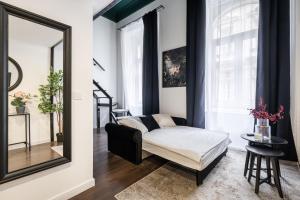 a living room with a mirror and a couch at E41 - Trendy Boutique Apartments - Prime Spot by BQA in Budapest