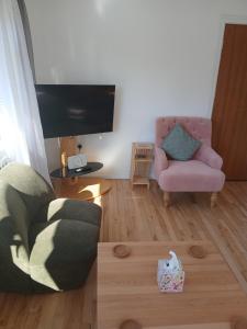 a living room with a couch and a chair at Hillside in Ewyas Harold
