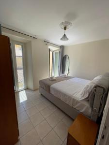 a bedroom with a bed and a mirror on the wall at Campanile in Corfu