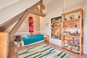 a room with a loft bed and a book shelf at Jolie Maison En Pierres in Saint-Martin-de-la-Cluze