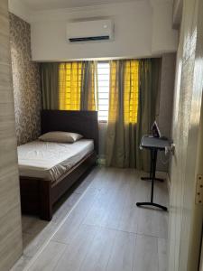 a small bedroom with a bed and a desk at 11th on Ampang in Ampang +4 photos