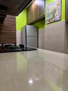 a kitchen with a stove and a refrigerator at 11th on Ampang in Ampang