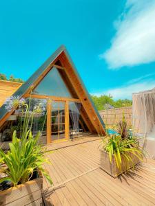 a house with a wooden deck with plants at Sapanca Sis Vadi Bungalov in Sapanca