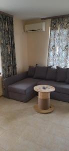 a living room with a couch and a table at Sea View in Topola +16 photos