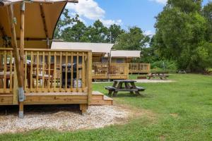 a group of picnic tables and benches in a park at On The Lake #116 in Onalaska