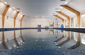 an empty swimming pool in a building at Les Jardins de Durbuy in Durbuy