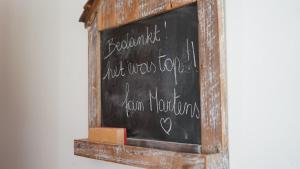 a chalkboard with writing on it on a wall at Villa Jeanne Dusschaut in Flobecq +35 photos