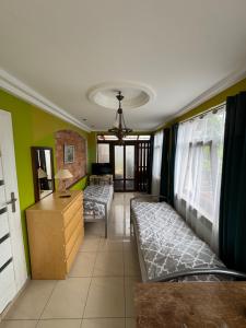 a living room with two beds and a desk at Pokoje pod winogronami in Płoty