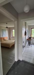 a bedroom with a bed and a table in it at Nature lovers house izbeigts in Stacija Bērstele