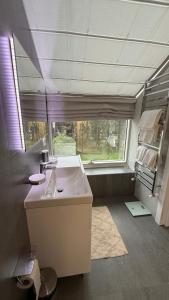 a bathroom with a sink and a large window at Hotel Maria in Rădăuţi +57 photos