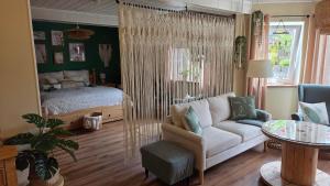 a living room with a bed and a couch at FeWo Naturtraum in Kastellaun