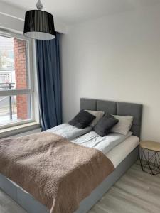 a bed with two pillows on it in a bedroom at Apartamenty Platinum 4 in Gdańsk