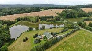 eine Luftansicht eines Hauses auf einem Bauernhof neben einem See in der Unterkunft Dolina 3 Stawów Tarnawka in Handzlówka