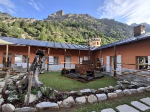 a house with a garden in front of a mountain at Cà d'Margherita and Heidi in Valdieri
