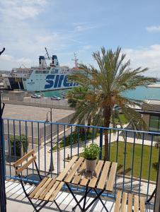 a balcony with a bench and a cruise ship at Fronteporto in Porto Empedocle