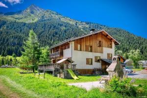 a house with a slide in front of a mountain at Chalet la Grande Motte in Champagny-en-Vanoise +30 photos