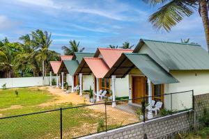 a row of houses with red roofs at Avila Nilaveli Beach in Nilaveli