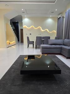 a living room with a couch and a table at 5 Bedroom semi detached Apartment by Ellestar Homes in Lekki