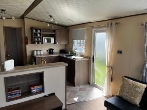 a small kitchen with a sink and a counter at 33 millennium gardens in Whitley Bay +12 photos