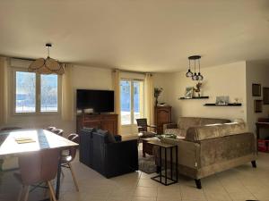 a living room with a couch and a table at Appartement au cœur de Villard de Lans avec grande terrasse et double garage - FR-1-548-47 in Villard-de-Lans