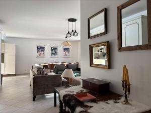 a living room with a couch and a table at Appartement au cœur de Villard de Lans avec grande terrasse et double garage - FR-1-548-47 in Villard-de-Lans