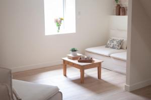 a living room with a couch and a coffee table at Maison de vacances avec cave voûtée entre Lyon et Beaune in Givry +31 photos
