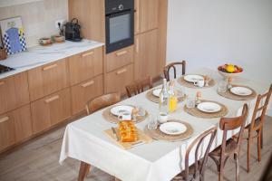 a kitchen with a table with plates of food on it at Maison de vacances avec cave voûtée entre Lyon et Beaune in Givry