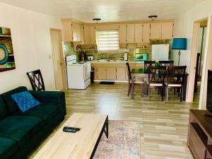 a living room with a couch and a table and a kitchen at Pedro's Hideaway in Mangilao