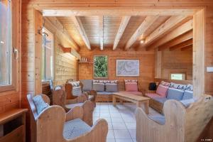 a living room with couches and chairs in a cabin at Chalet la Grande Motte in Champagny-en-Vanoise
