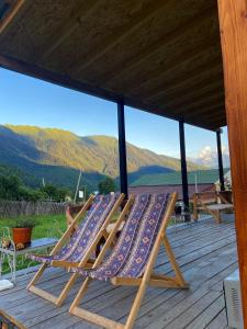 a deck with a lounge chair with a view of mountains at Guest House Shuan in Chokhuldi +24 photos