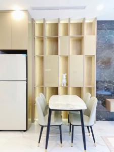 a dining room with a table and chairs and a refrigerator at 1BR Supper King View Vip Luxury in Long Bình