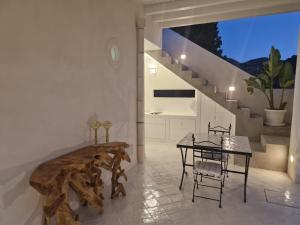a dining room with a table and a staircase at Sikelia elegant suite in Lipari