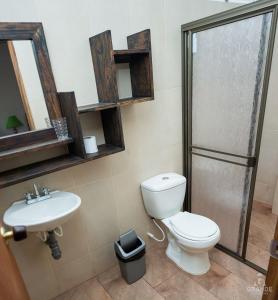 a bathroom with a toilet and a sink at Hotel Madre Laura Jericó in Jericó