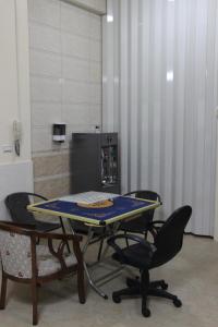 a table and chairs in a room with a tv at 懷東居 文旅苑民宿 可包棟 近金城 in Jinning