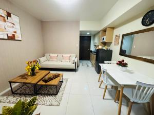 a living room with a couch and a table at Brenthill Condominium in Baguio