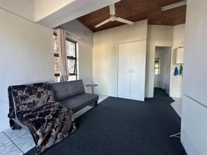 a living room with a couch and a table at Suite Dreams Spacious Apartment in Panorama +18 photos