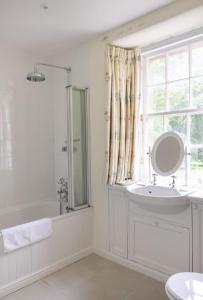 a white bathroom with a sink and a window at The Tower, Keith Marischal in Humbie +34 photos