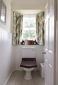 a bathroom with a toilet and a window at The Tower, Keith Marischal in Humbie