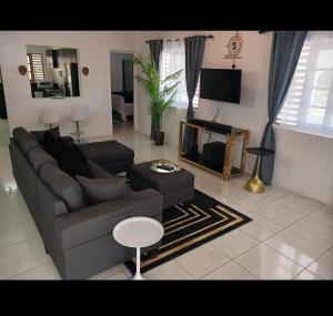 a living room with a couch and a table at Holiday Oasis in Ocho Rios