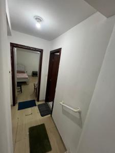 a room with a hallway with a mirror and a door at Casa Camburi 1 in Vitória