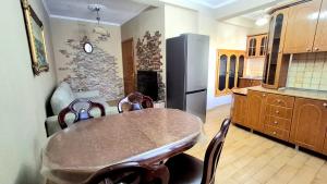 a kitchen with a table and a refrigerator at The Sweet Home in Pogradec