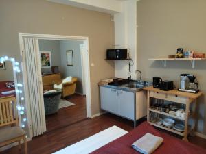 a kitchen with a sink and a counter in a room at Brahe Suite, free parking garage in Turku