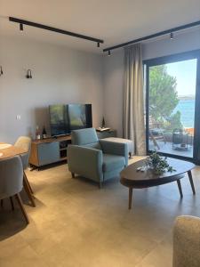 a living room with a couch and a table at Five shades of blue in Vourvourou